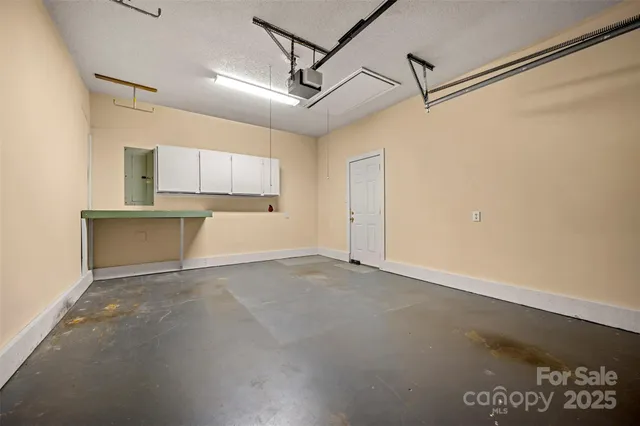 a view of a kitchen with a sink and a refrigerator