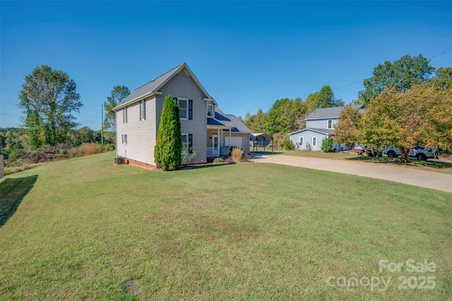 a view of a house with a yard and garage