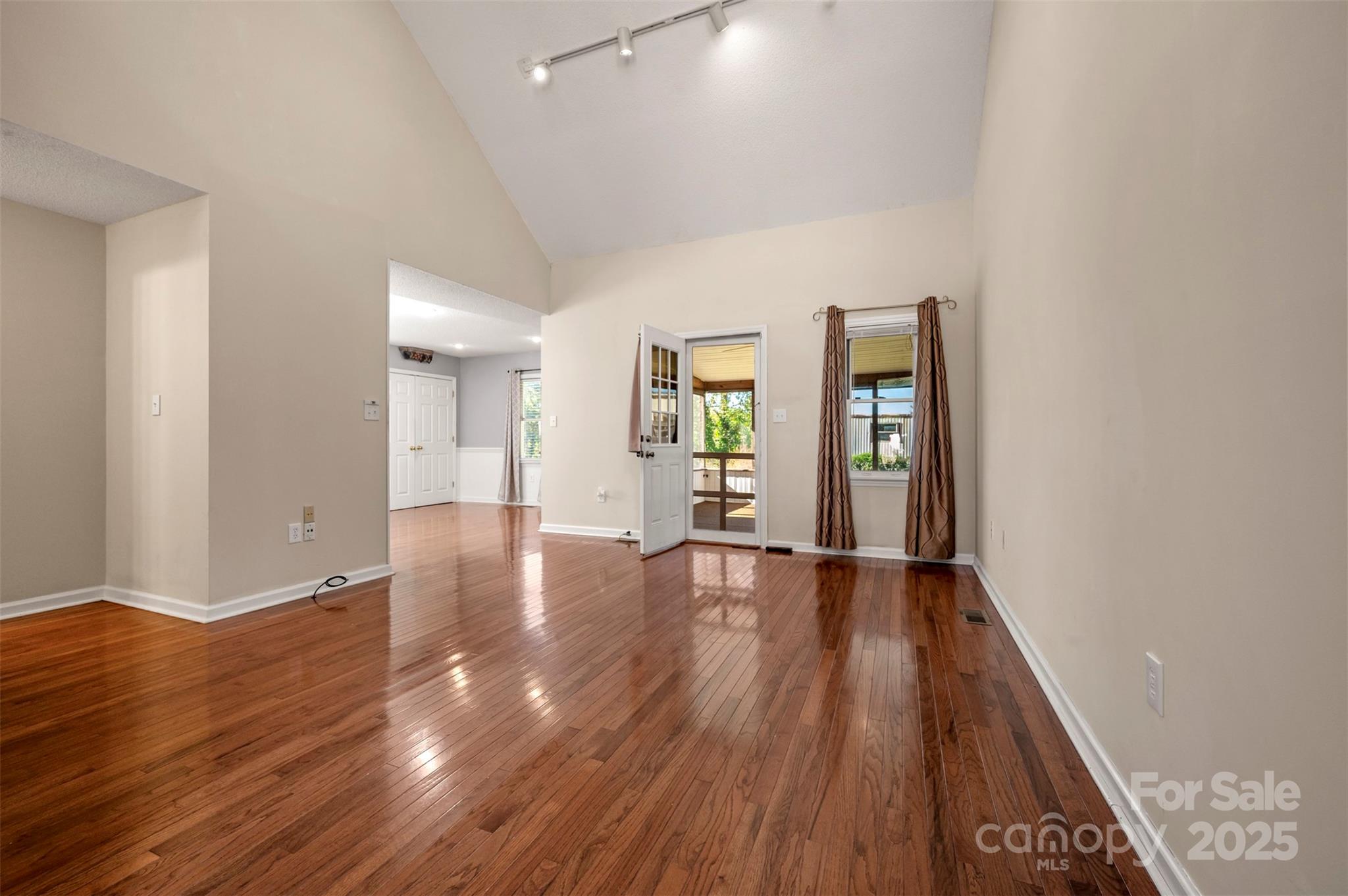 506 Pleasant Street Spindale, NC 28160 - Photo 4 of 34 wooden floor in an empty room with a window