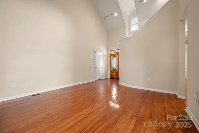 a view of an empty room and wooden floor