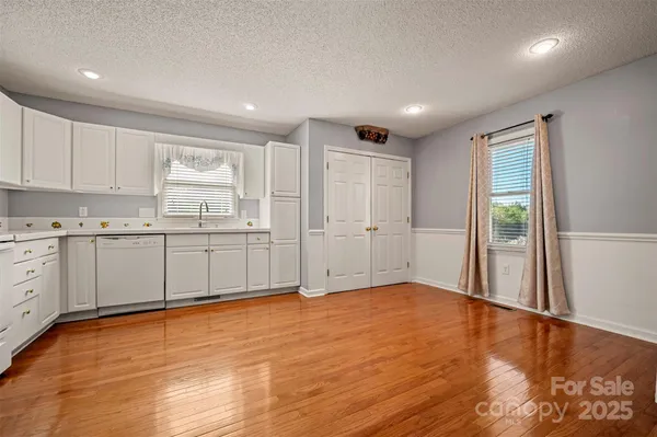 a view of a kitchen with wooden cabinet and a window