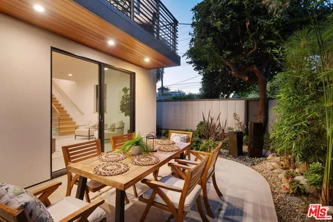 an outdoor space with patio furniture and potted plants