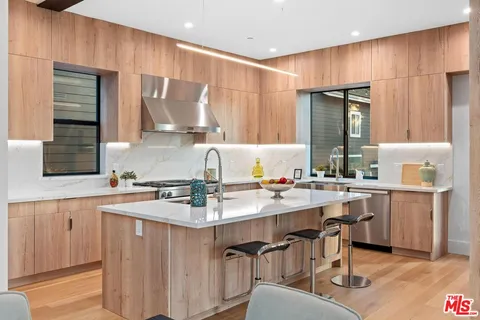 a kitchen with sink stove and cabinets