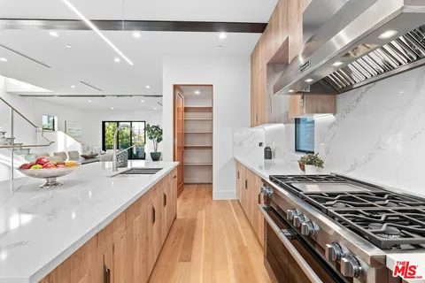 a kitchen with stainless steel appliances a sink stove and refrigerator