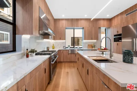a kitchen with stainless steel appliances kitchen island granite countertop a sink and a stove