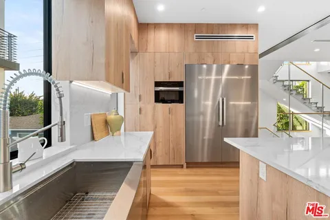 a kitchen with a stove a sink and a refrigerator