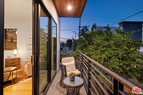 a bedroom with furniture and a large window