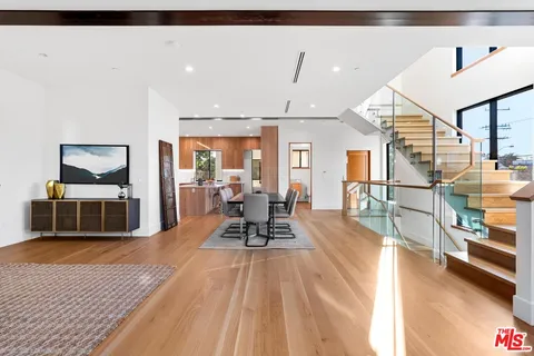 a bedroom with a bed and a view of living room