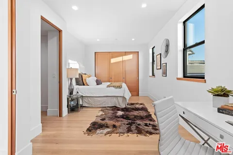 a bathroom with a granite countertop sink mirror vanity toilet and bathtub