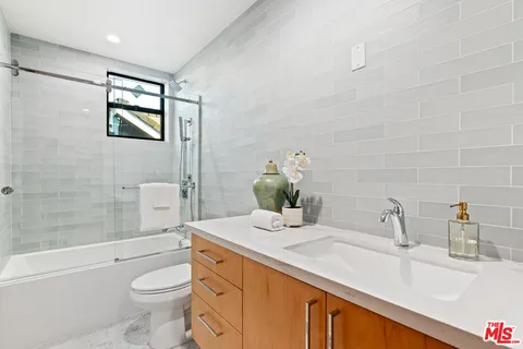 a bedroom with a bed and large window