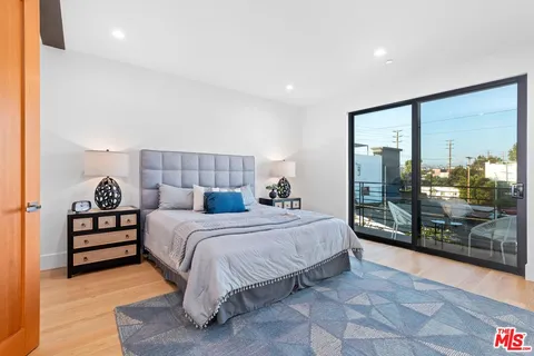 a bedroom with a large bed and a large window