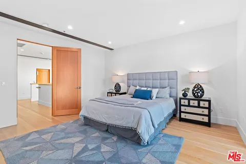 a bathroom with a granite countertop sink a toilet a mirror and shower