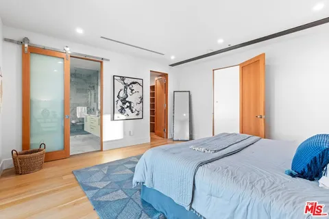 a bathroom with a granite countertop sink a mirror and shower
