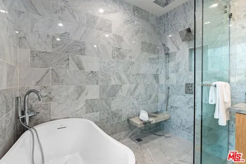 a bedroom with a bed and a mirror