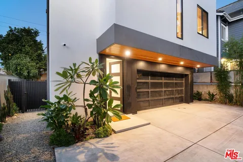 a view of a house with a yard and garage