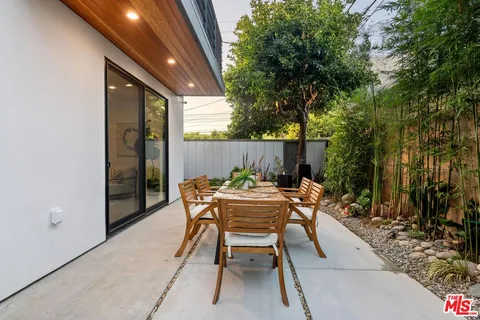 a view of a backyard with furniture and outdoor space