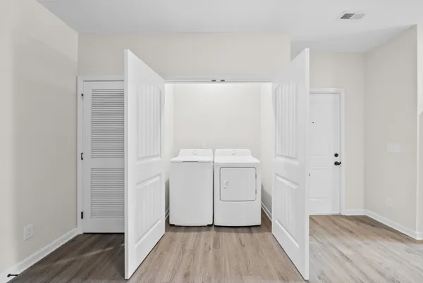 a view of a room with wooden floor and white doors