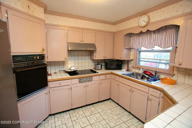 a kitchen with a sink cabinets and window