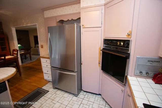 a kitchen with stainless steel appliances granite countertop a refrigerator and a stove top oven
