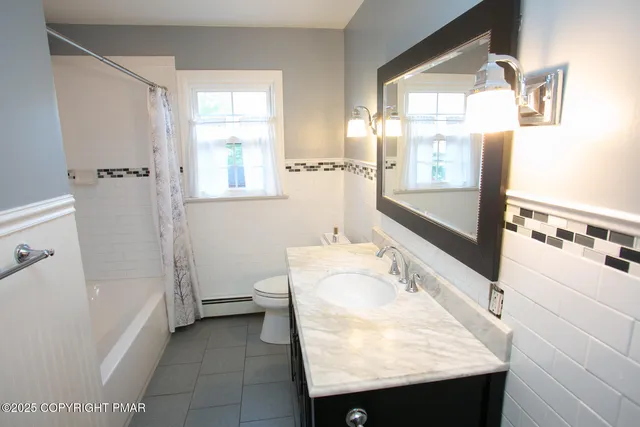 a bathroom with a shower and a shower head