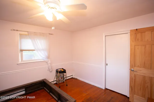 a view of a room with wooden floor