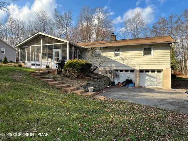a front view of house with yard outdoor seating and barbeque oven