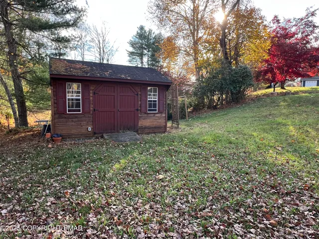 a red brick house with trees in front of it
