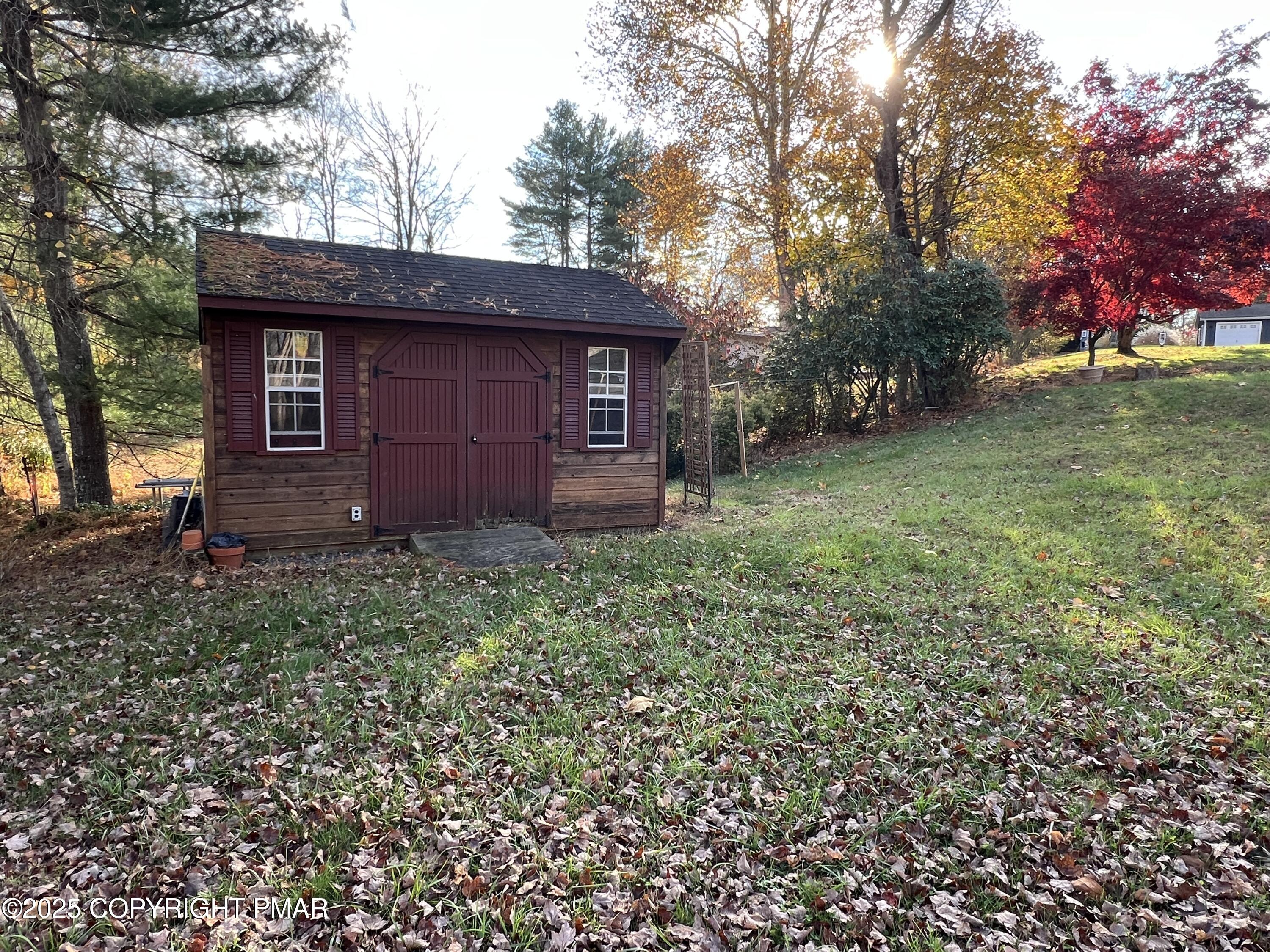 202 Norton Road Stroudsburg, PA 18360 - Photo 7 of 35 a red brick house with trees in front of it