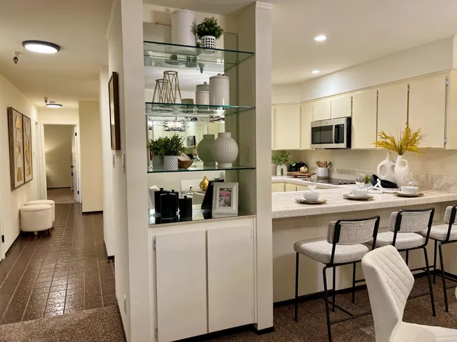 a kitchen with stainless steel appliances kitchen island granite countertop a sink and cabinets