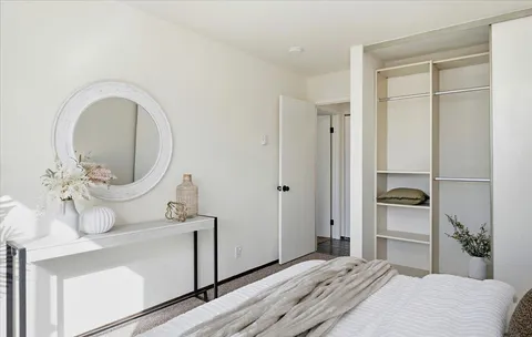 a bedroom with a bed and a mirror