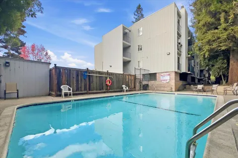 a view of a swimming pool with a back yard