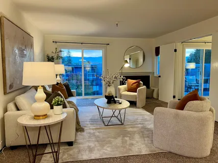 a living room with furniture and a lamp