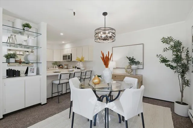 a view of a dining room with furniture wooden floor and chandelier
