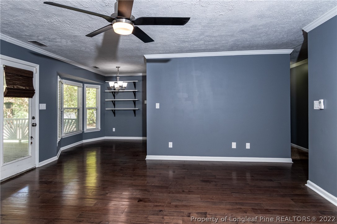 7070 Rockfish Road Raeford, NC 28376 - Photo 9 of 37 a view of an empty room with window and wooden floor
