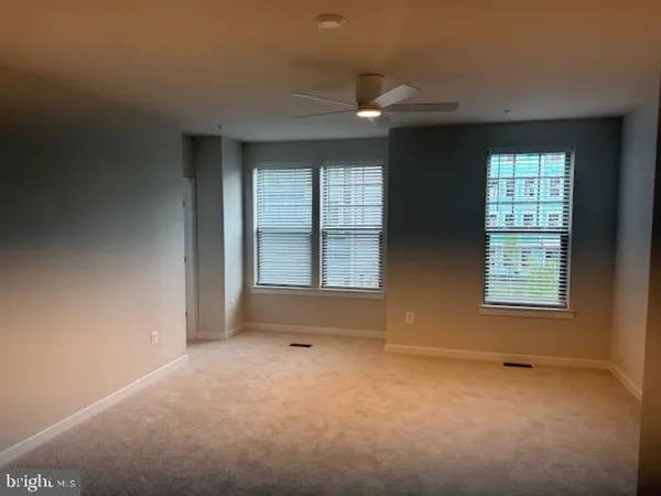 an empty room with a empty space and windows