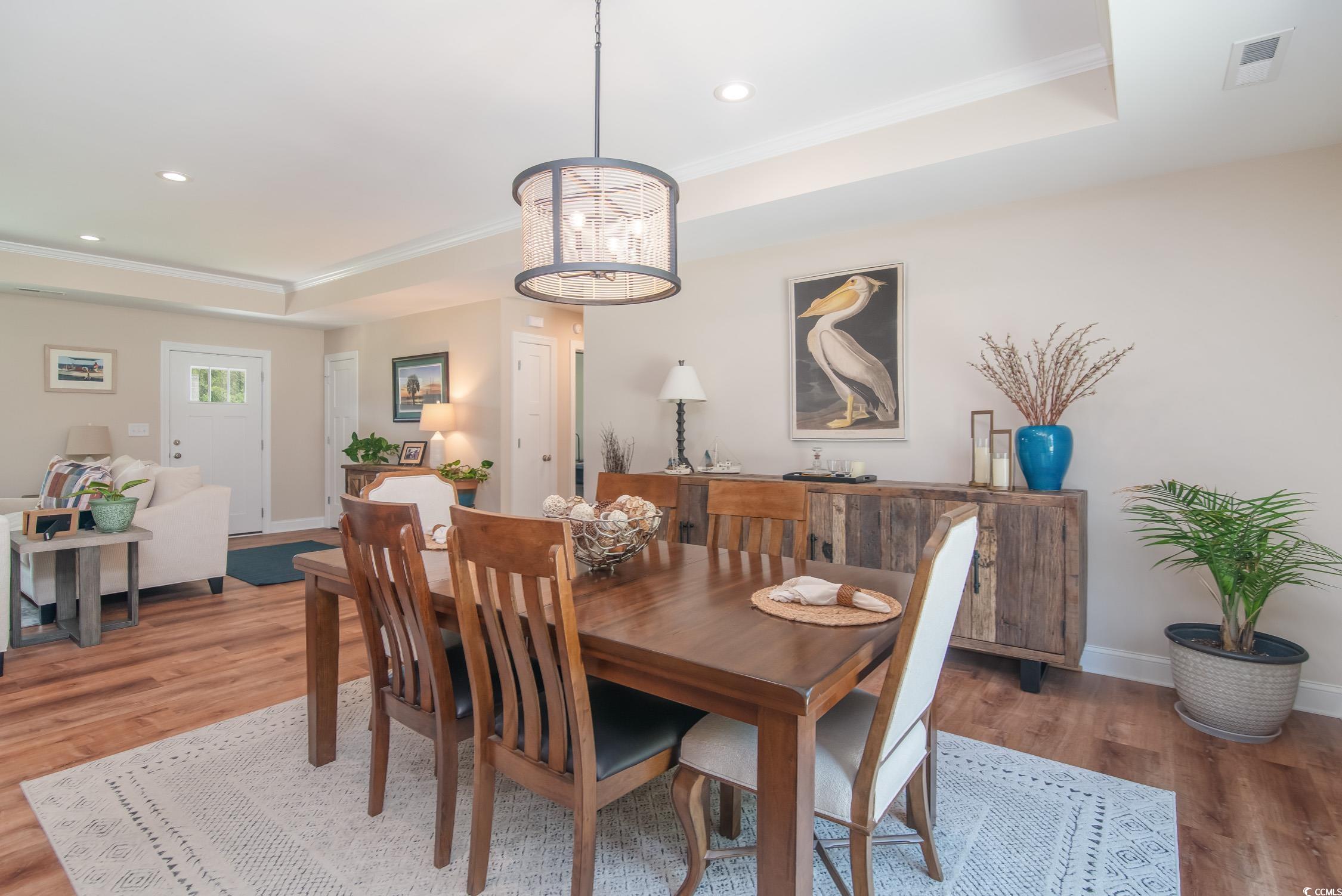 193 Field Loop Road Georgetown, SC 29440 - Photo 14 of 40 Dining room featuring a raised ceiling, light wood