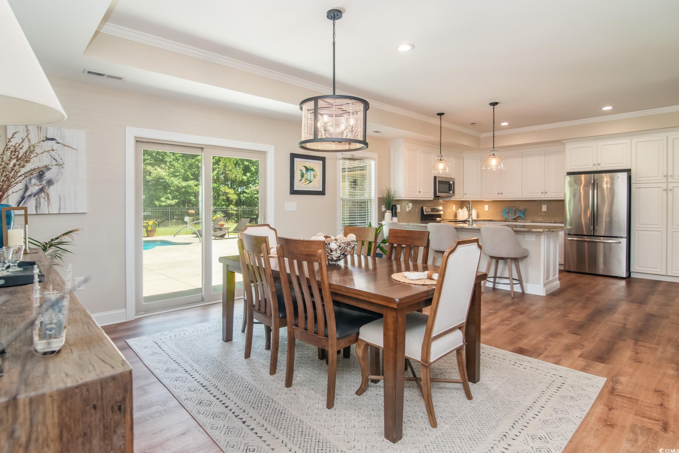 193 Field Loop Road Georgetown, SC 29440 - Photo 16 of 40 Dining room with crown molding, a tray ceiling, wo