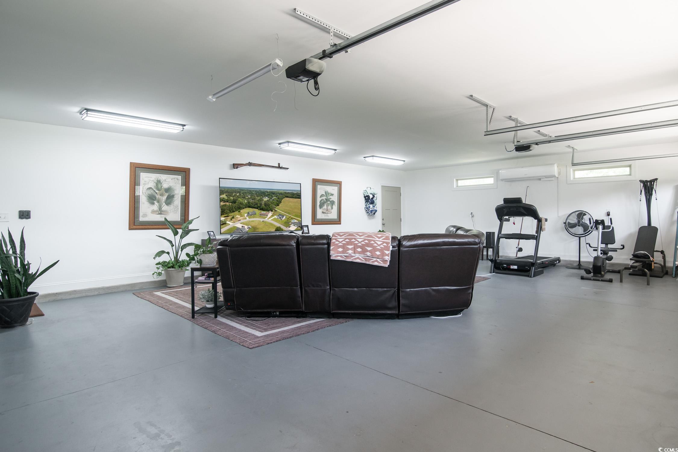 193 Field Loop Road Georgetown, SC 29440 - Photo 27 of 40 Living area with a garage, concrete flooring, and