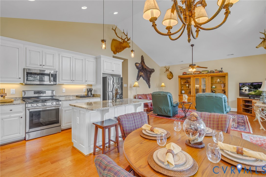 200 Pinetop Road Topping, VA 23169 - Photo 14 of 38 Dining space featuring a chandelier, light wood fi