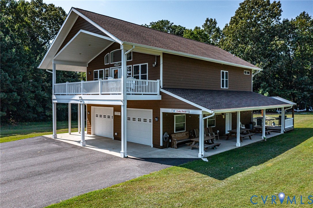 200 Pinetop Road Topping, VA 23169 - Photo 2 of 38 View of front of house with driveway, a balcony, r