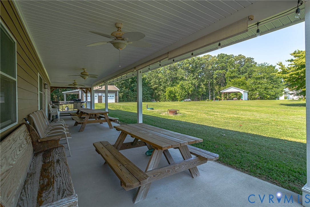 200 Pinetop Road Topping, VA 23169 - Photo 25 of 38 View of patio with outdoor dining area and ceiling