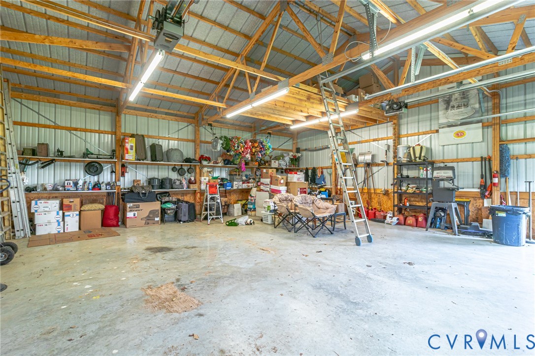 200 Pinetop Road Topping, VA 23169 - Photo 34 of 38 Garage with metal wall, a garage door opener, and