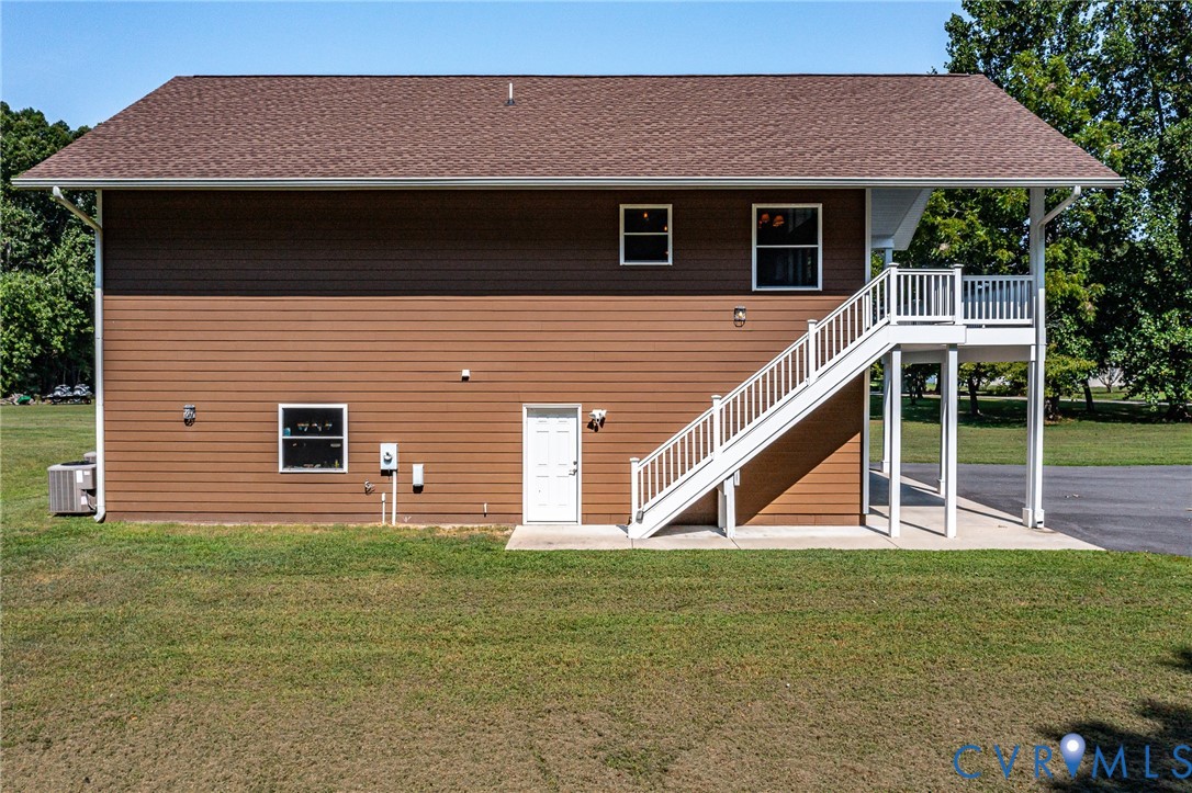 200 Pinetop Road Topping, VA 23169 - Photo 4 of 38 Side view of property featuring a yard, stairs, a