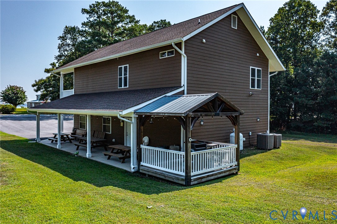 200 Pinetop Road Topping, VA 23169 - Photo 5 of 38 Back of property featuring a yard, a patio, roof w