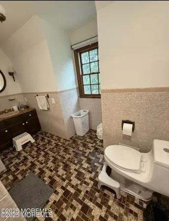 a bathroom with a toilet and a window