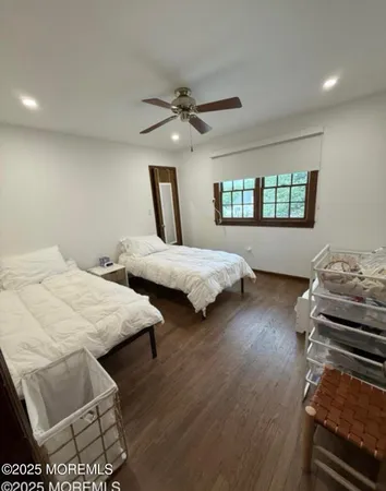a bedroom with two beds and a chandelier