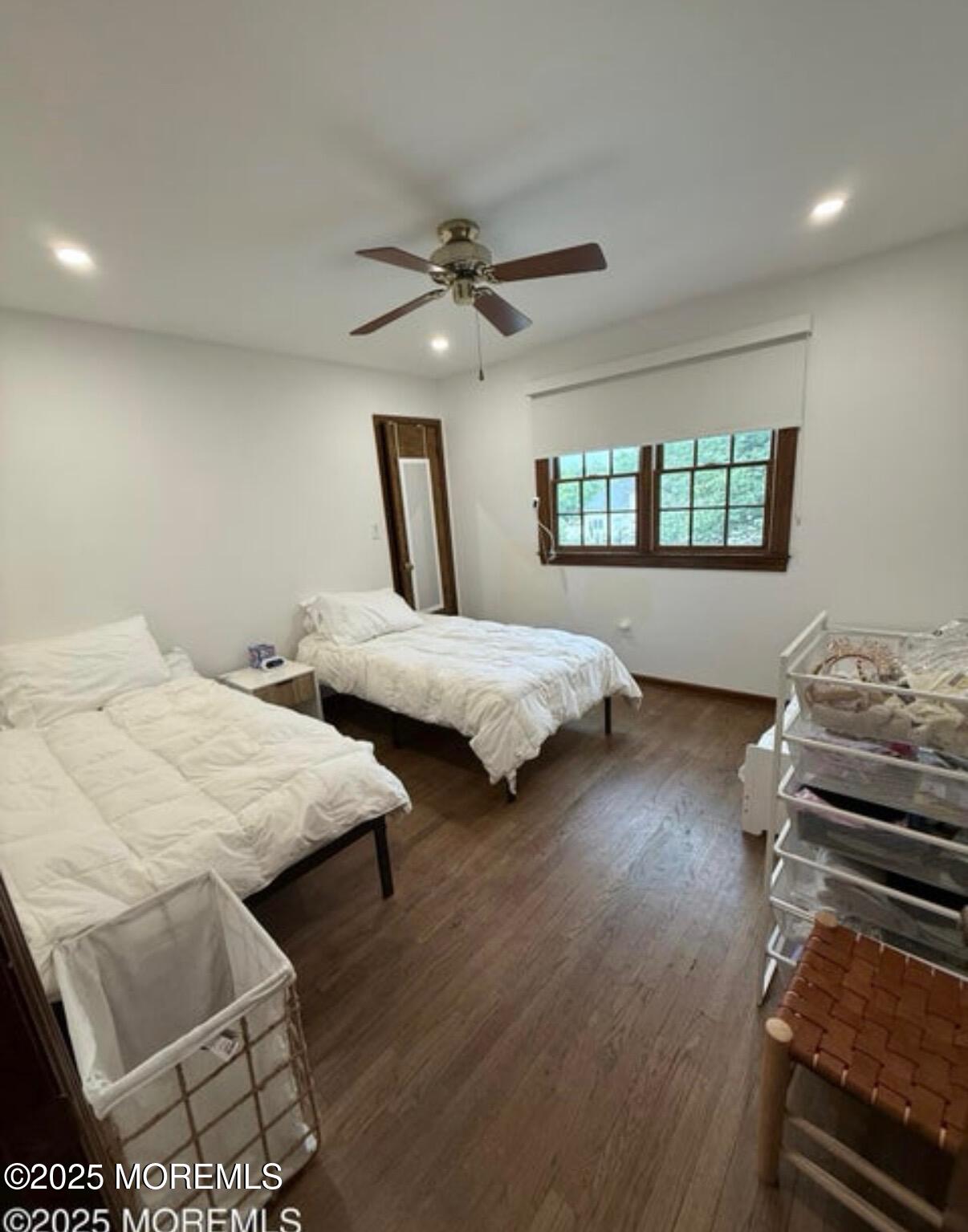 530 Wall Street Eatontown, NJ 07724 - Photo 8 of 13 a bedroom with two beds and a chandelier