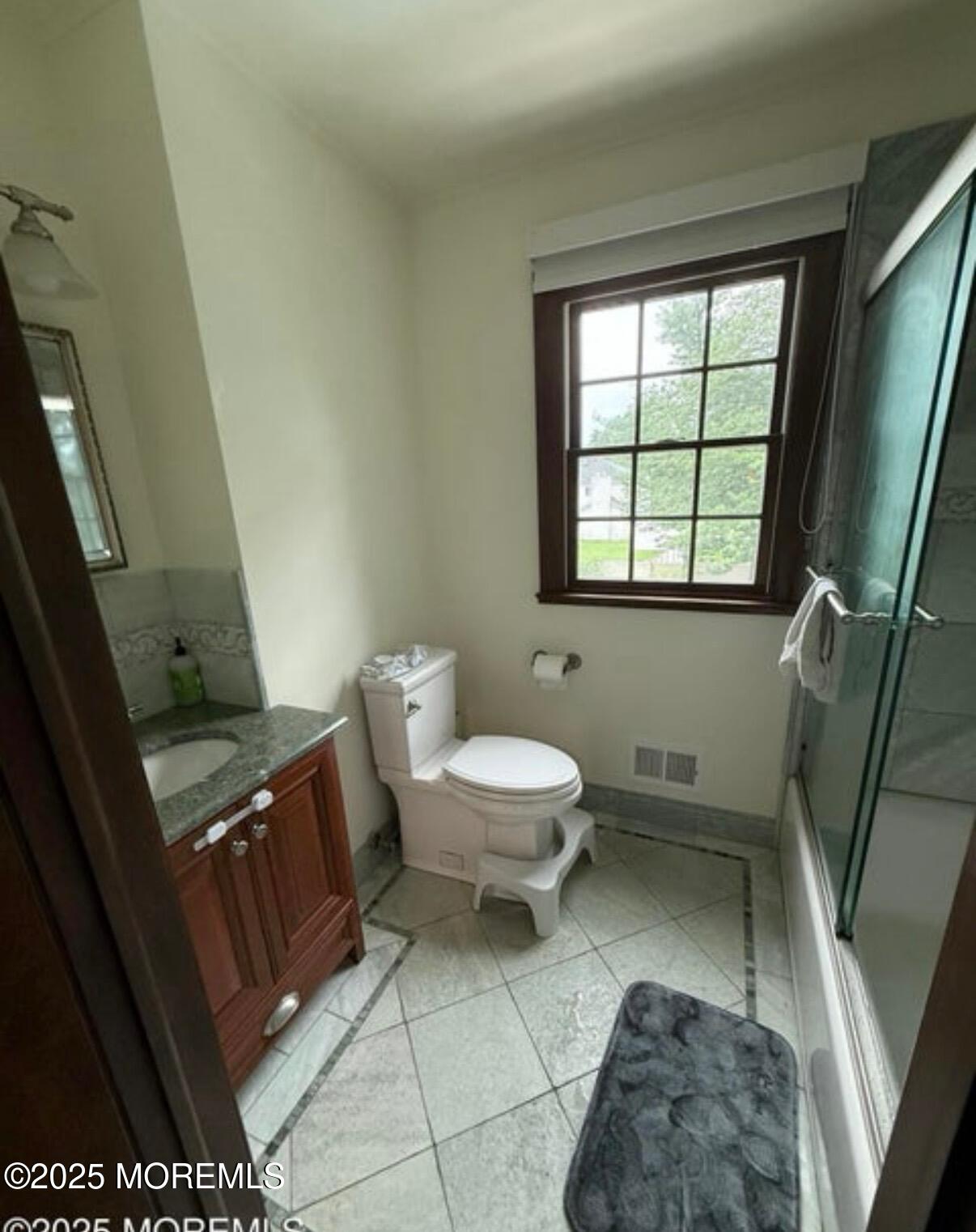 530 Wall Street Eatontown, NJ 07724 - Photo 9 of 13 a bathroom with a toilet a sink and a window