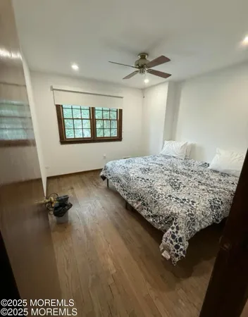 a bedroom with a bed dresser and a window