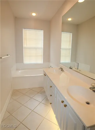 a bathroom with a tub sink and window